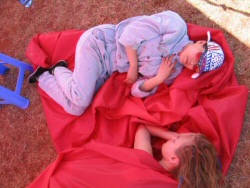 Taking a nap after lunch on top of the canvas of one of the wind-blown tents