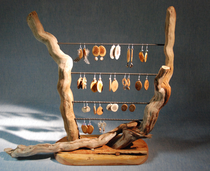 This jewellery holder shows earrings we have handmade using wood, antler, feathers, etc.