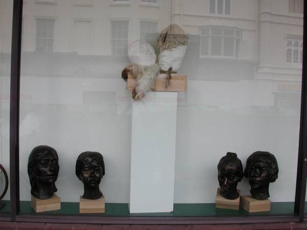 Middle section of window in gallery showing sculptures by Laury Dizengremel