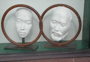Two Ring Face sculptures side by side