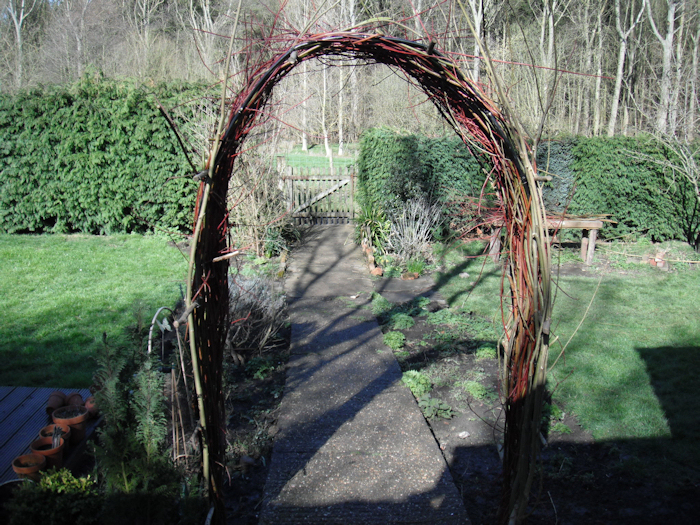 Living willow structures can help to frame a view, as well as offer shelter from heavy rain