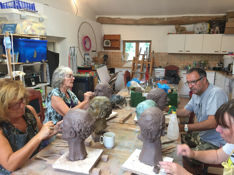 Sculpture students modelling clay busts